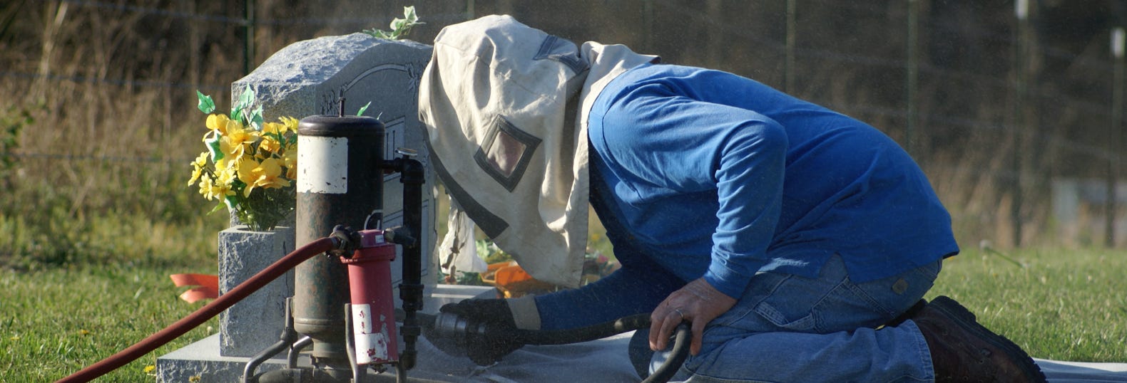 Sandblasting in a cemetery